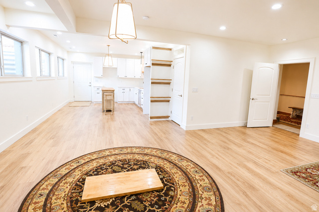1055 North 1000 East Mapleton, UT 84664 - Photo 53 of 112 Open-concept living space featuring wood-finish flooring, recessed lighting, and a kitchen area with white cabinetry