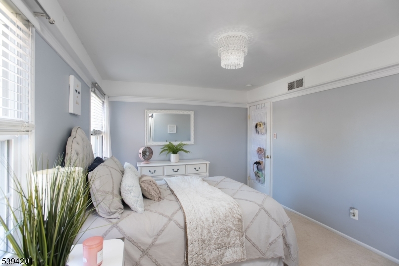 4 Marshall Road Hillsborough, NJ 08844 - Photo 18 of 38 a bedroom with a bed and a chandelier