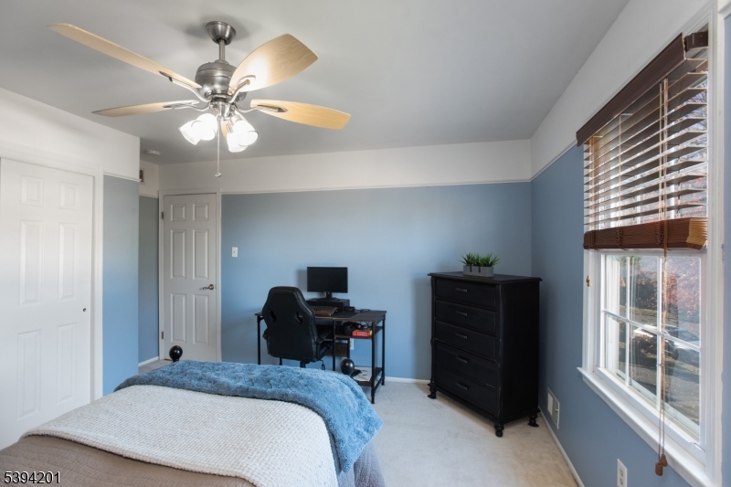 4 Marshall Road Hillsborough, NJ 08844 - Photo 20 of 38 a bedroom with a bed and a chandelier