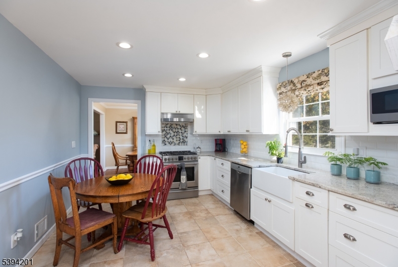 4 Marshall Road Hillsborough, NJ 08844 - Photo 2 of 38 a kitchen with a dining table chairs and white cabinets