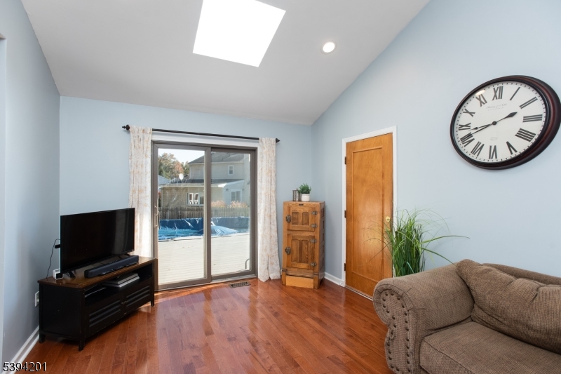 4 Marshall Road Hillsborough, NJ 08844 - Photo 9 of 38 a living room with furniture a flat screen tv and a large window