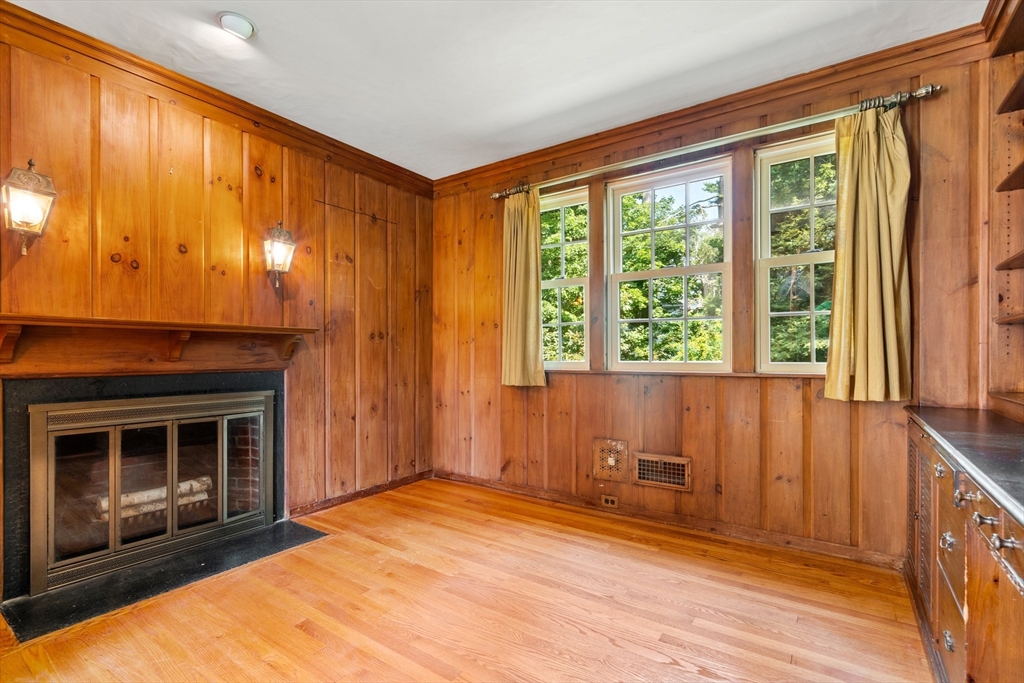 2 Kenilworth Road Wellesley, MA 02482 - Photo 16 of 41 a view of empty room with wooden floor and fireplace