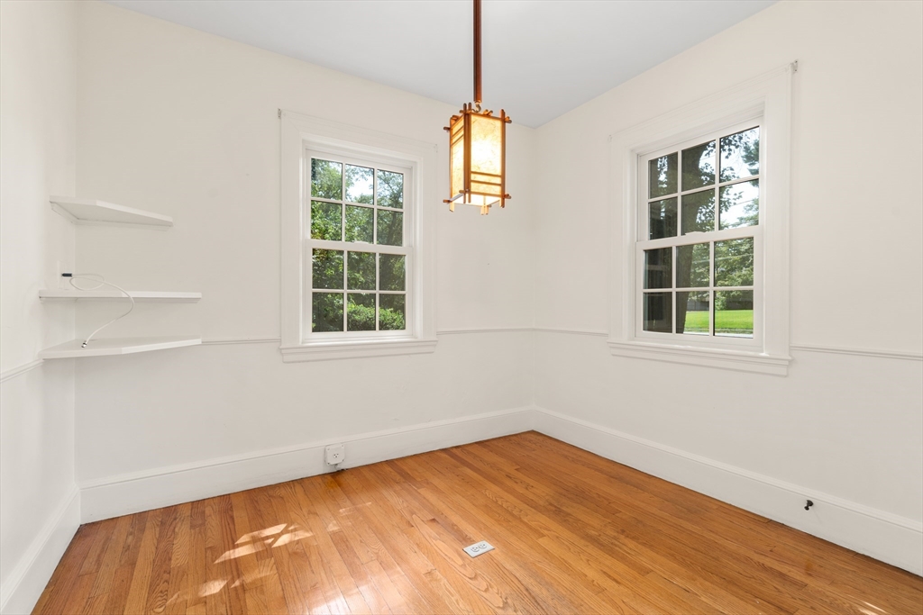 2 Kenilworth Road Wellesley, MA 02482 - Photo 17 of 41 a view of an empty room with wooden floor and windows