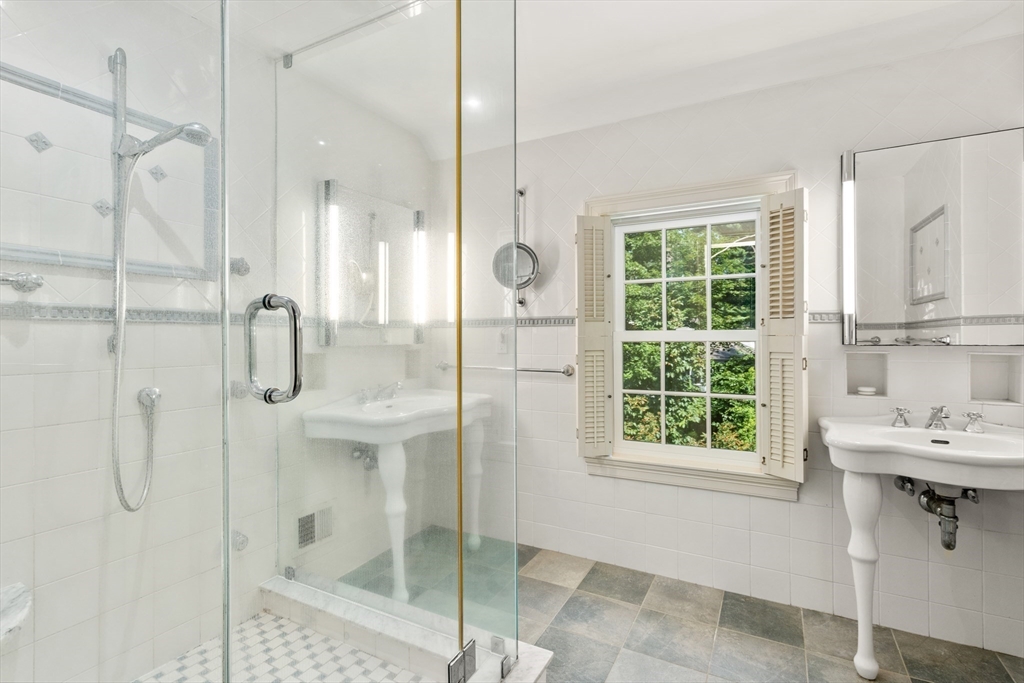 2 Kenilworth Road Wellesley, MA 02482 - Photo 23 of 41 a bathroom with a shower sink and mirror