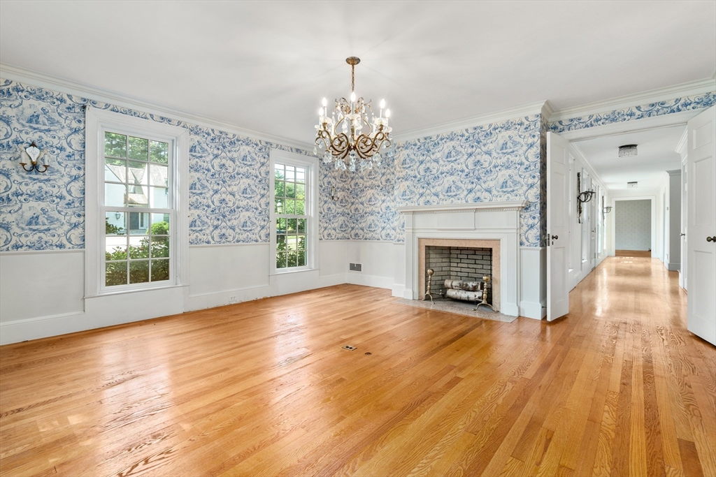 2 Kenilworth Road Wellesley, MA 02482 - Photo 6 of 41 a view of a livingroom with wooden floor a fireplace and windows