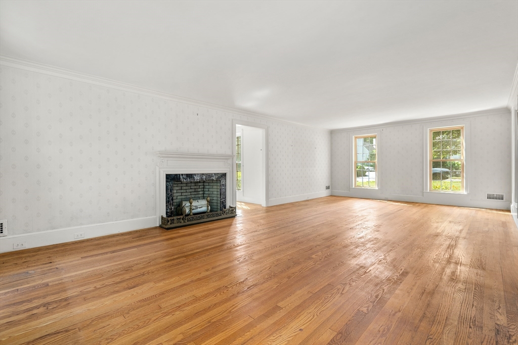 2 Kenilworth Road Wellesley, MA 02482 - Photo 10 of 41 an empty room with wooden floor fireplace and windows