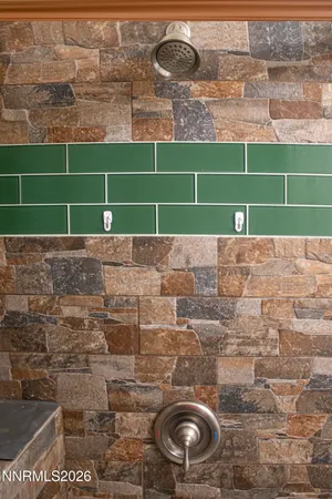 a white toilet sitting next to a white sink and cabinets