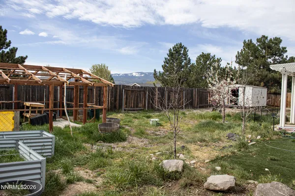 a house view with a sitting space fire pit and outdoor seating