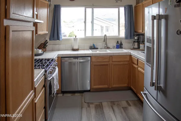 a kitchen with a sink stove and refrigerator