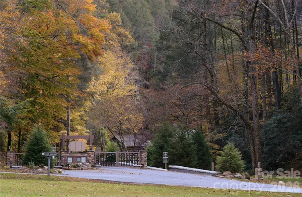 a view of a fountain with large trees