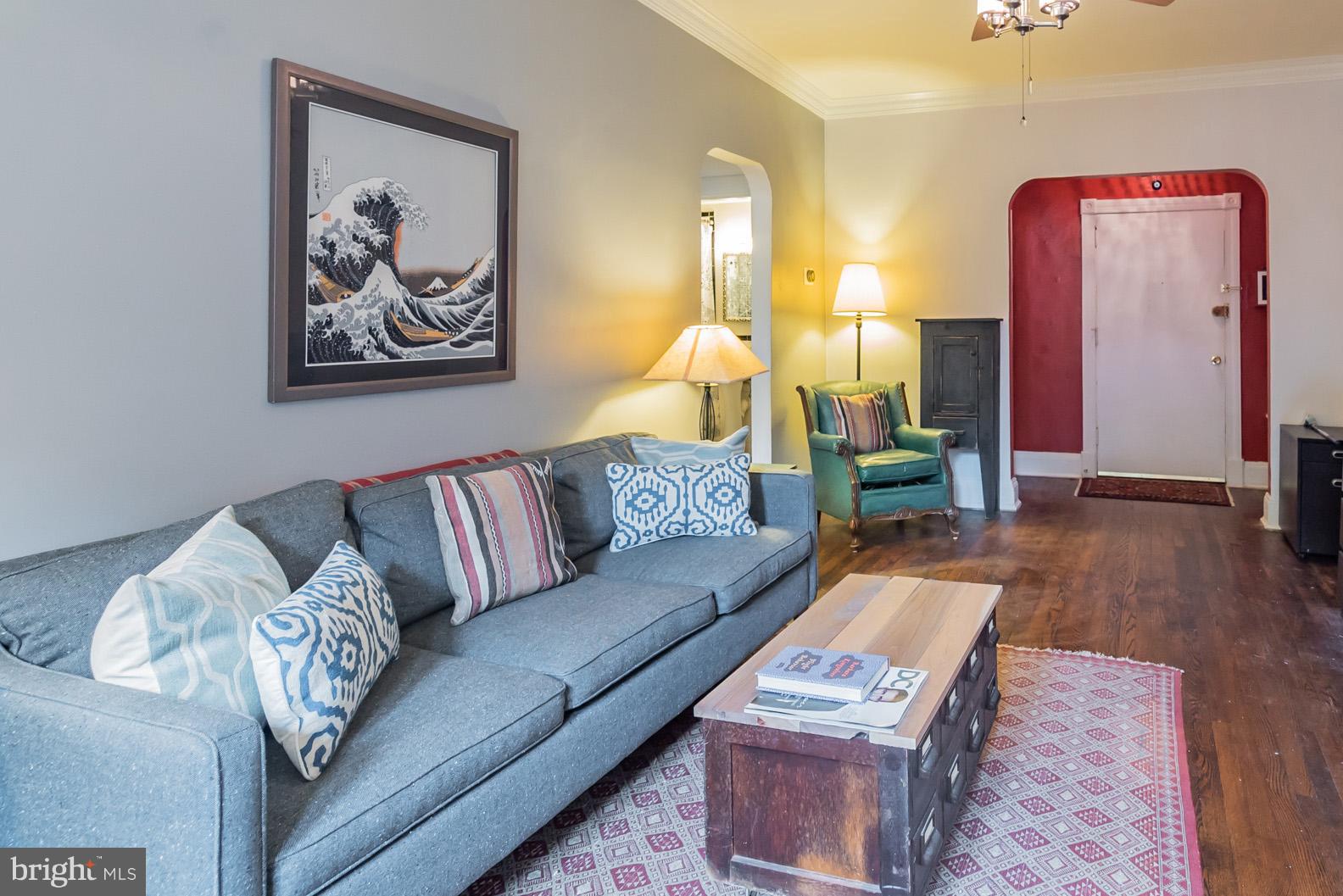 115 D Street Southeast, Unit 103 Washington, DC 20003 - Photo 2 of 14 a living room with furniture and wooden floor