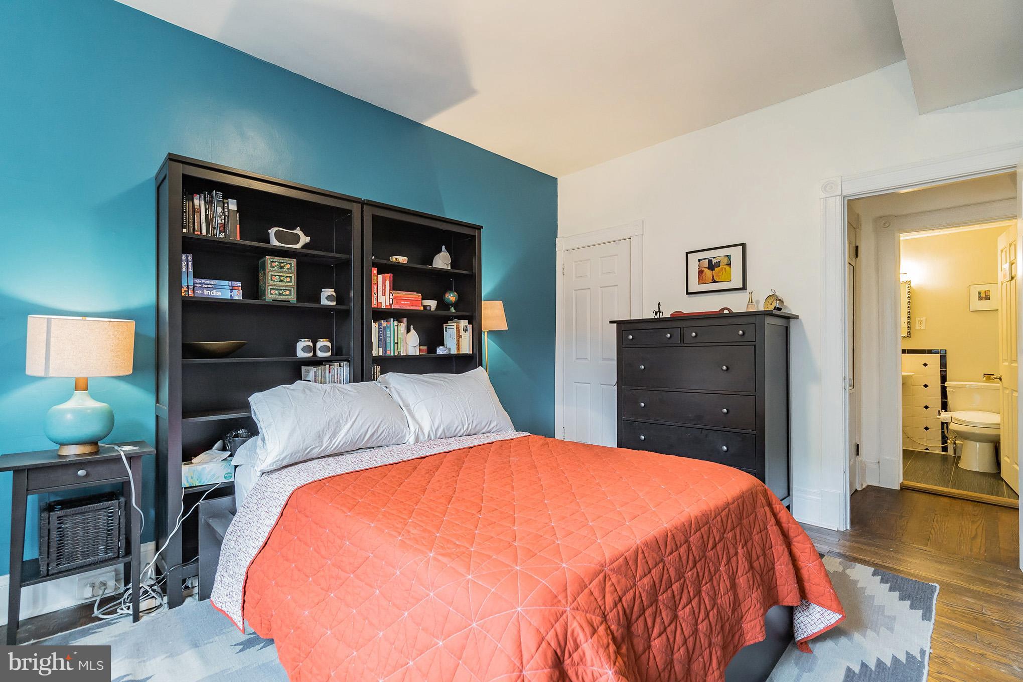 115 D Street Southeast, Unit 103 Washington, DC 20003 - Photo 6 of 14 a bed sitting in a bedroom and a table in a bedroom