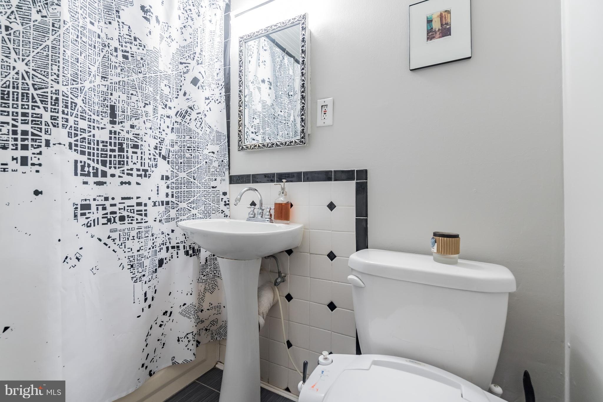 115 D Street Southeast, Unit 103 Washington, DC 20003 - Photo 7 of 14 a bathroom with a sink toilet and a mirror