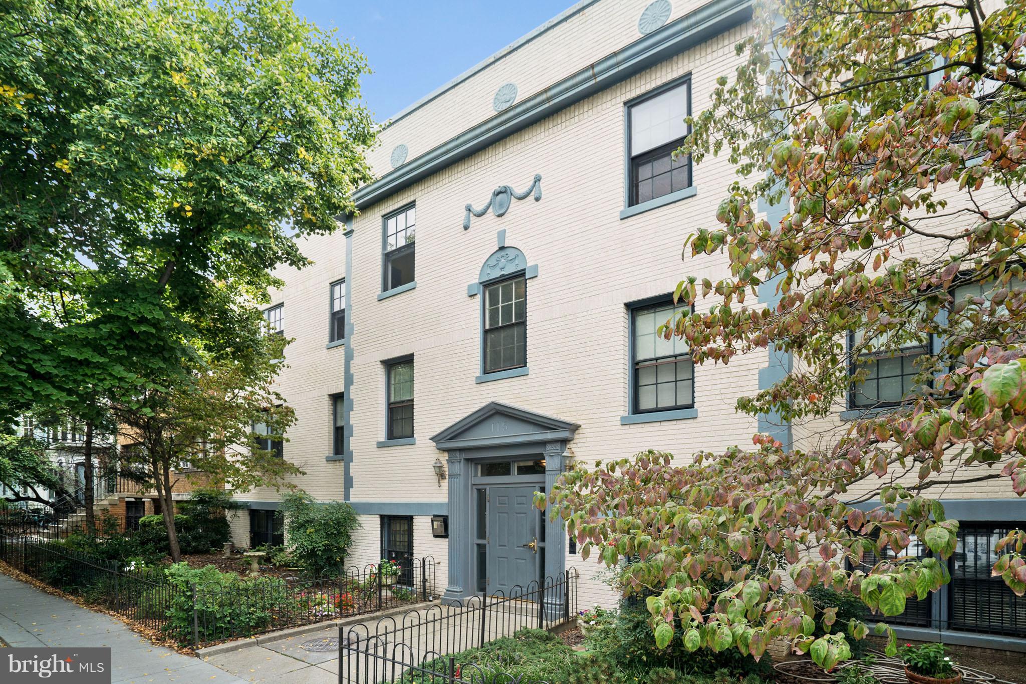 115 D Street Southeast, Unit 103 Washington, DC 20003 - Photo 10 of 14 a front view of a house with a garden