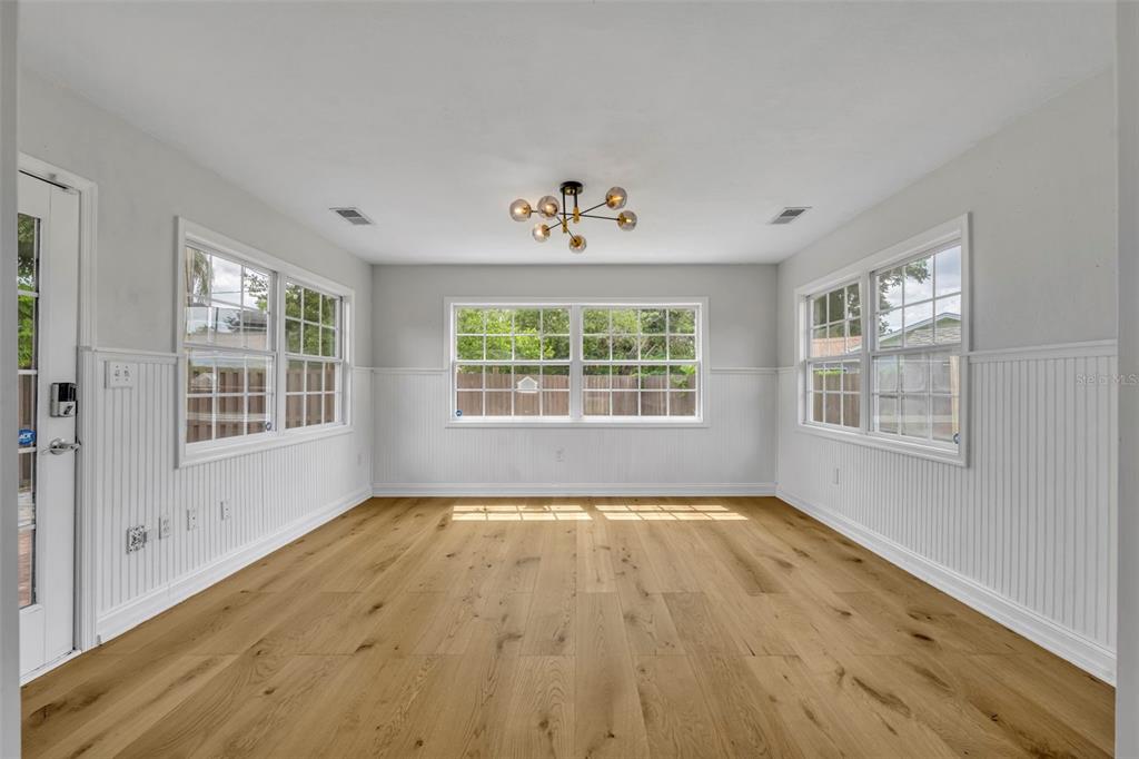 4234 Kendrick Road Orlando, FL 32804 - Photo 18 of 46 a view of an empty room with wooden floor and a window