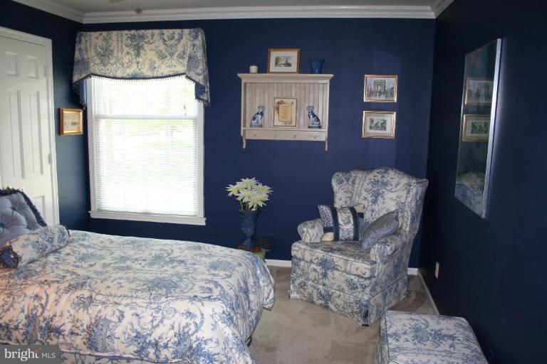 13703 Harcum Road Phoenix, MD 21131 - Photo 9 of 20 a bedroom with a bed mirror and window