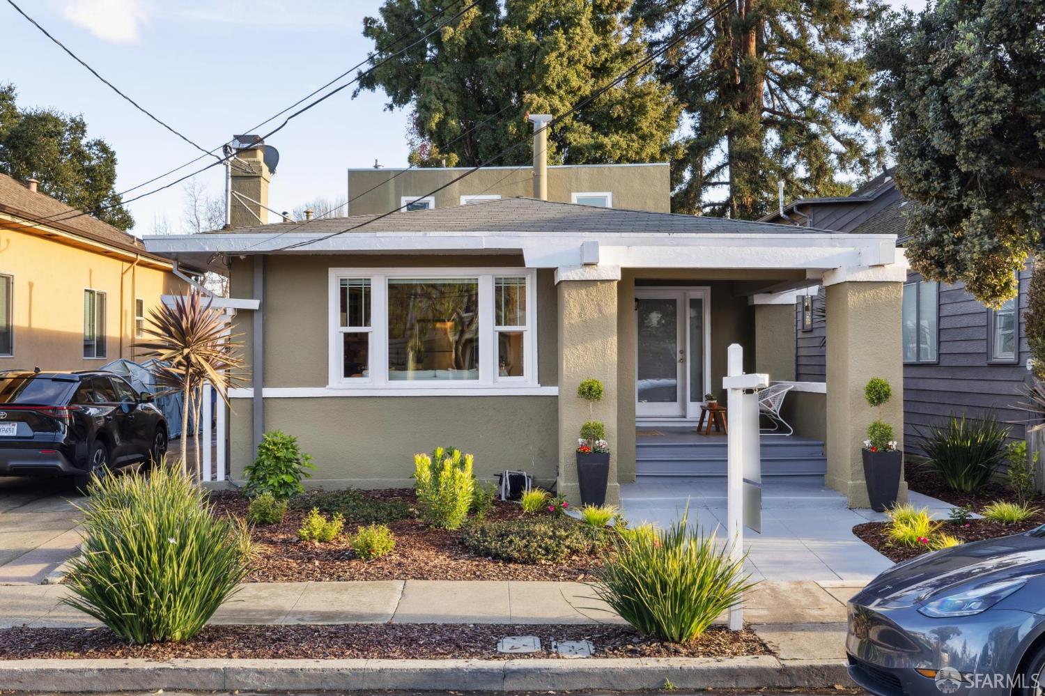 1314 Mound Street Alameda, CA 94501 - Photo 2 of 3 a front view of a house with outdoor seating and trees