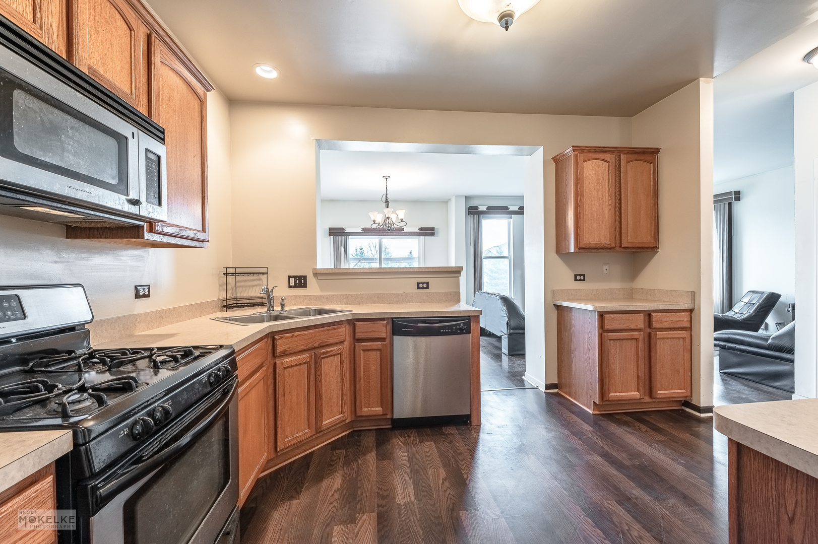 286 Wolverine Drive Oswego, IL 60543 - Photo 4 of 23 a large kitchen with stainless steel appliances granite countertop a stove a sink dishwasher and a microwave oven with wooden floor
