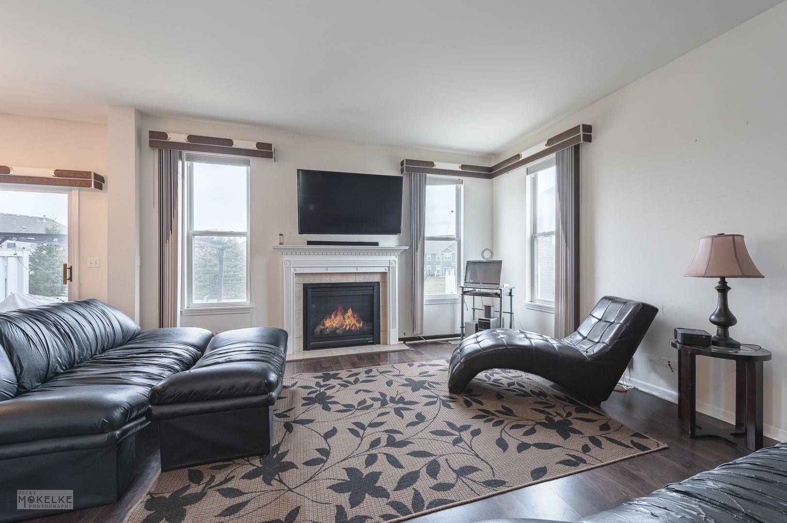 286 Wolverine Drive Oswego, IL 60543 - Photo 6 of 23 a living room with furniture a flat screen tv and a fireplace