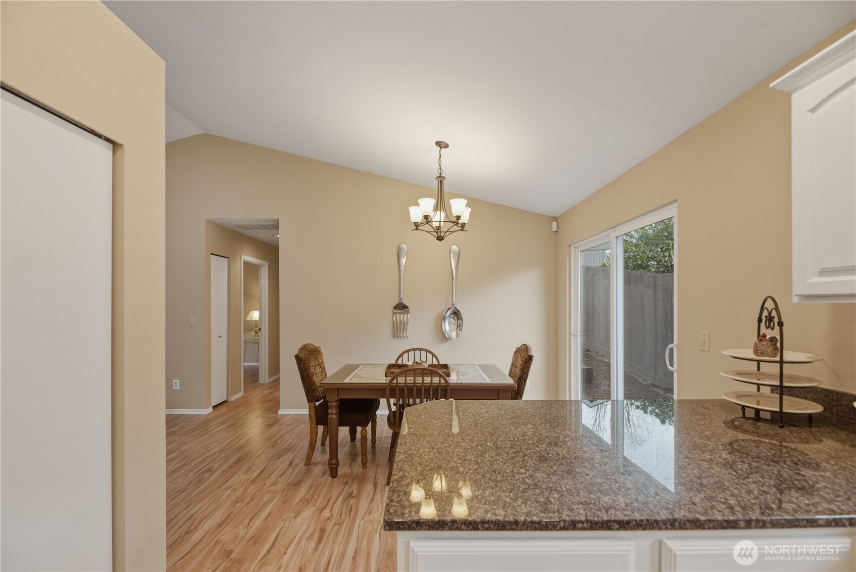2415 Southeast 8th Place Renton, WA 98057 - Photo 12 of 39 a view of a dining room with furniture and a chandelier