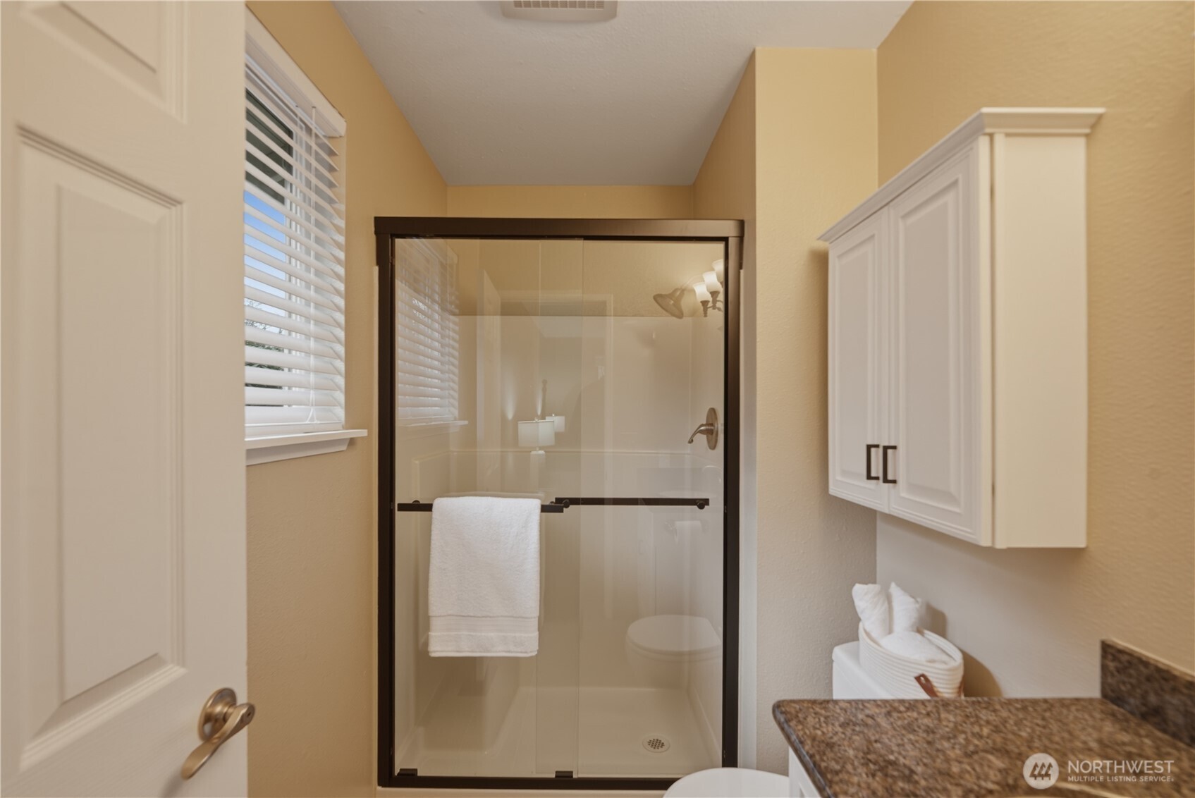 2415 Southeast 8th Place Renton, WA 98057 - Photo 18 of 39 a bathroom with a granite countertop shower and a sink