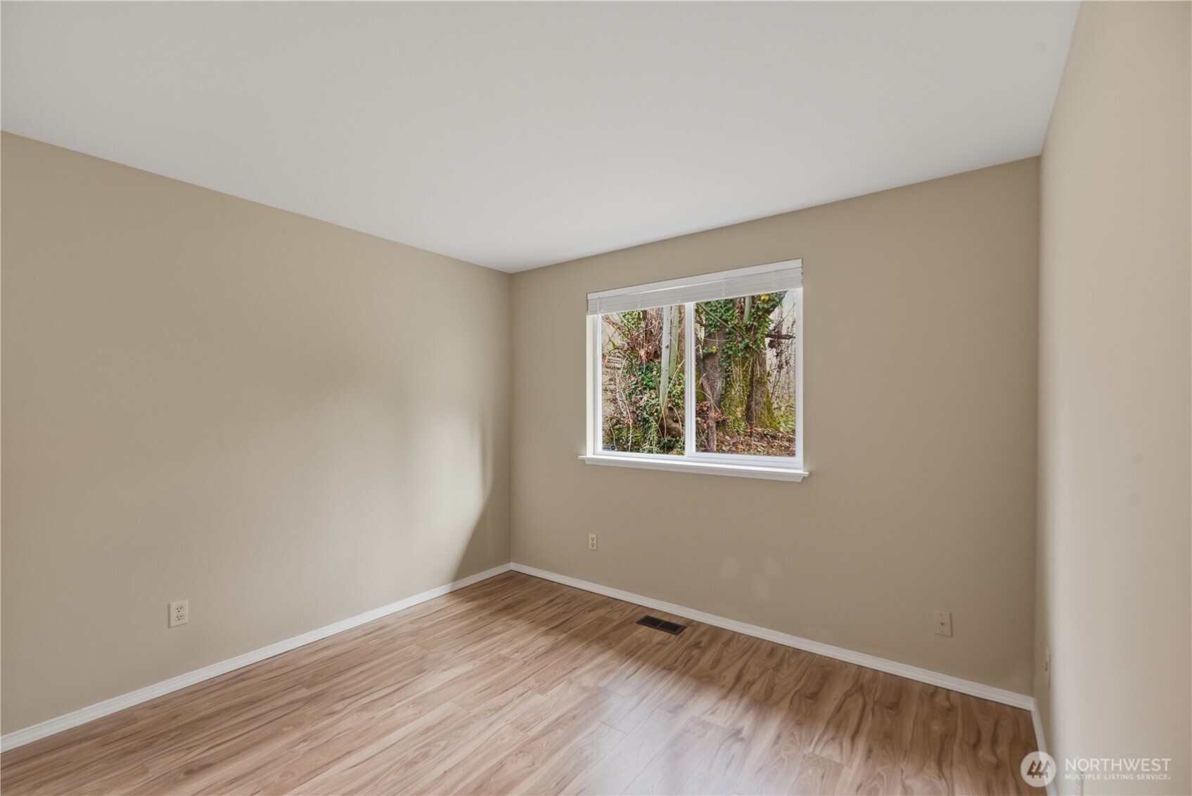 2415 Southeast 8th Place Renton, WA 98057 - Photo 20 of 39 a view of an empty room with wooden floor and a window