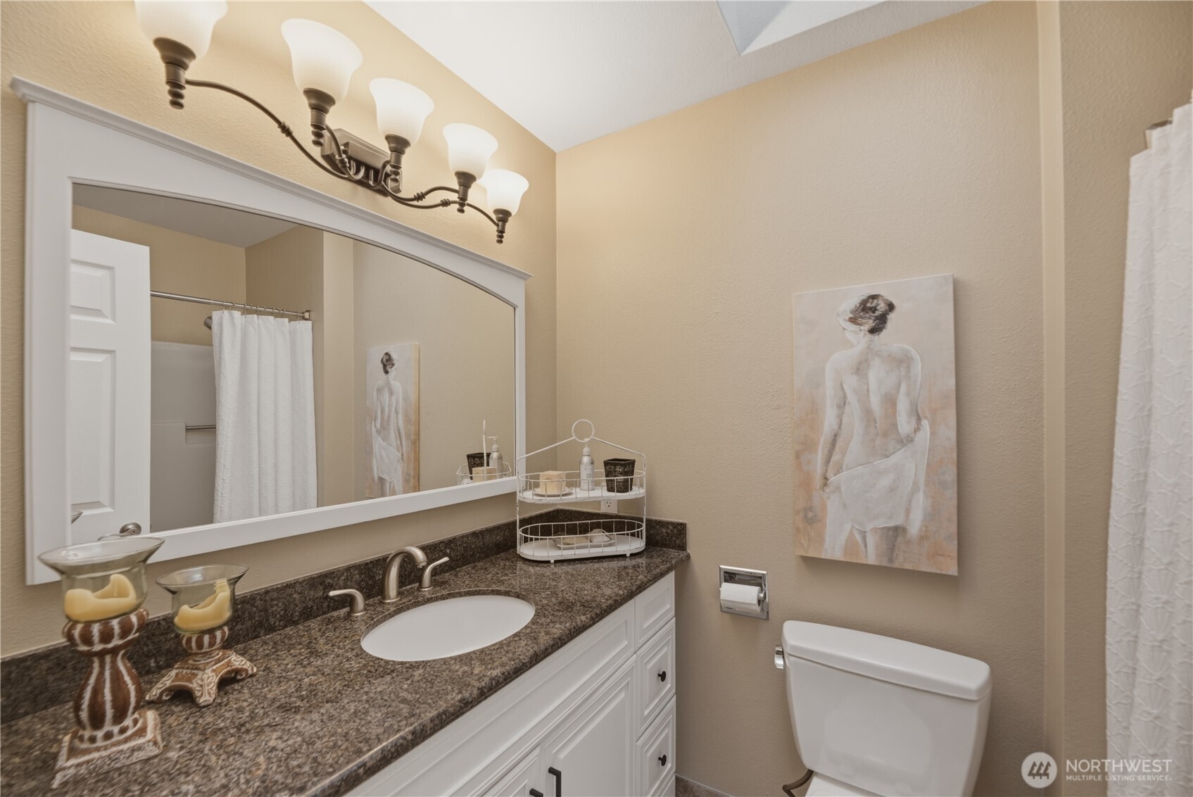 2415 Southeast 8th Place Renton, WA 98057 - Photo 22 of 39 a bathroom with a granite countertop sink a toilet and mirror