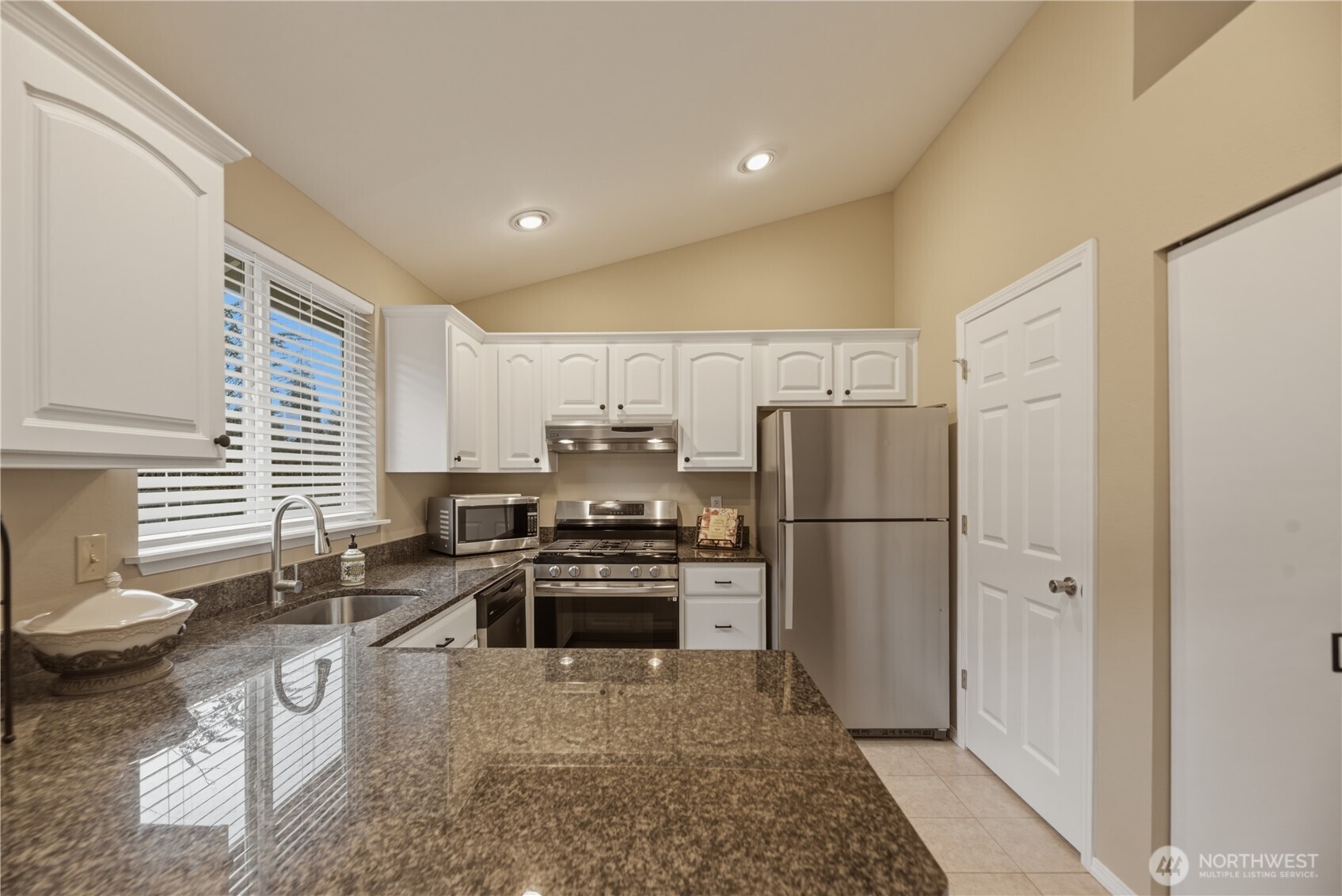 2415 Southeast 8th Place Renton, WA 98057 - Photo 31 of 39 a kitchen with stainless steel appliances granite countertop a refrigerator stove and sink