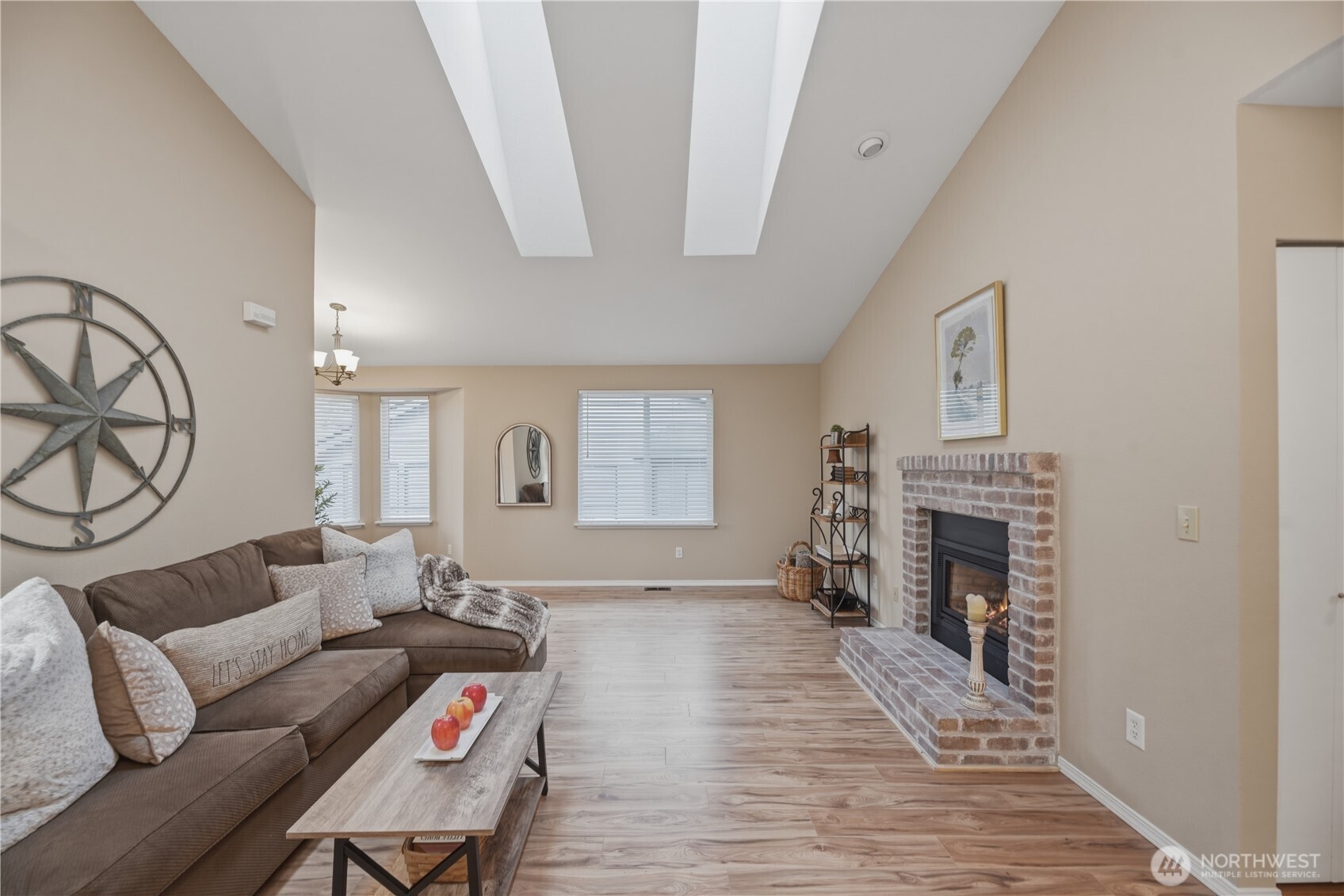2415 Southeast 8th Place Renton, WA 98057 - Photo 34 of 39 a living room with furniture a fireplace and a flat screen tv