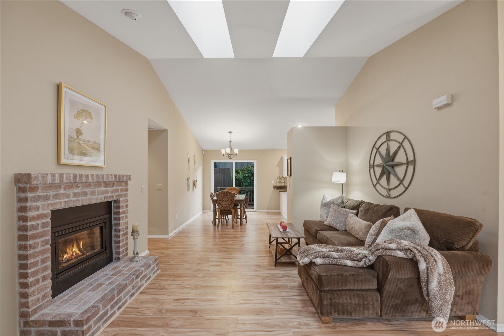 2415 Southeast 8th Place Renton, WA 98057 - Photo 5 of 39 a living room with furniture a clock and a fireplace