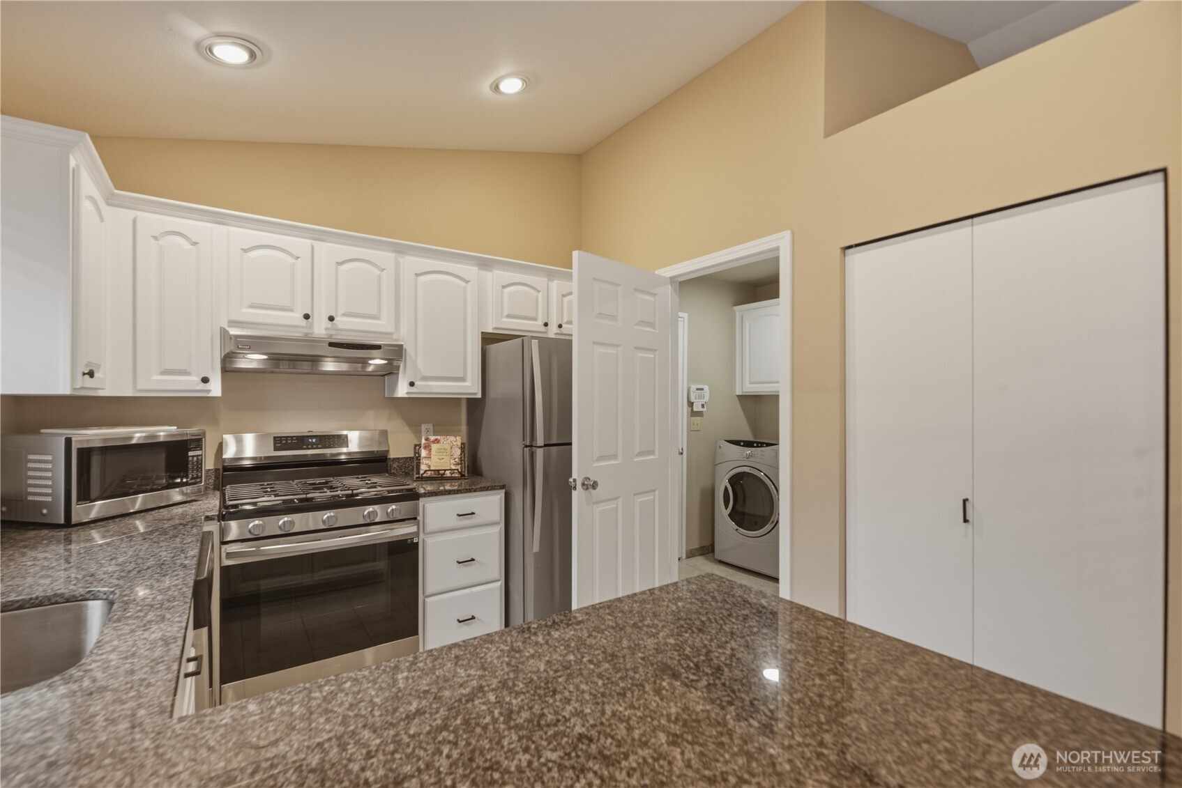 2415 Southeast 8th Place Renton, WA 98057 - Photo 9 of 39 a kitchen with a refrigerator and a stove top oven