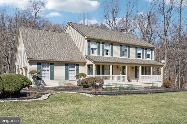 a front view of a house with yard and glass windows