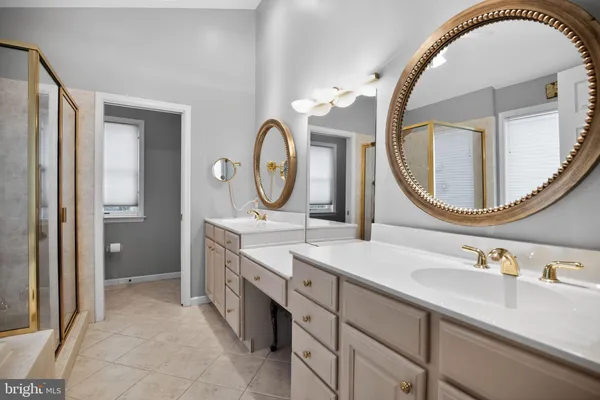 a bathroom with a double vanity sink and a mirror