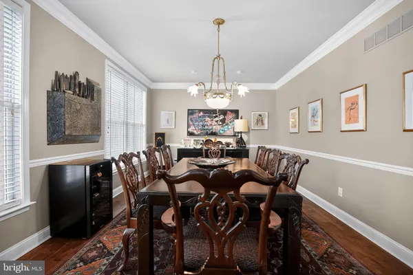 a view of a dining room with furniture and a chandelier