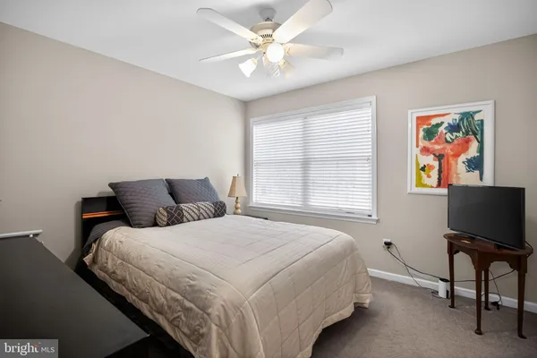 a bedroom with bed and a window