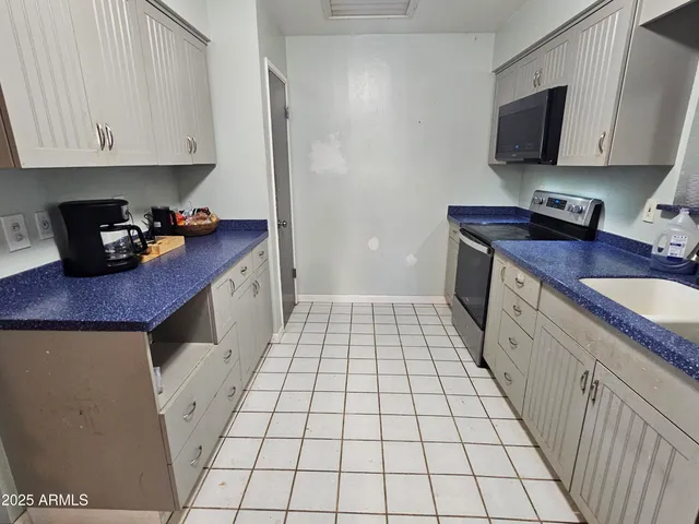 a kitchen with a sink and a stove top oven