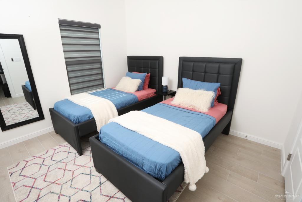 901 East Yuma Avenue, Unit 1806 McAllen, TX 78503 - Photo 9 of 12 a bedroom with two beds and painting on the wall
