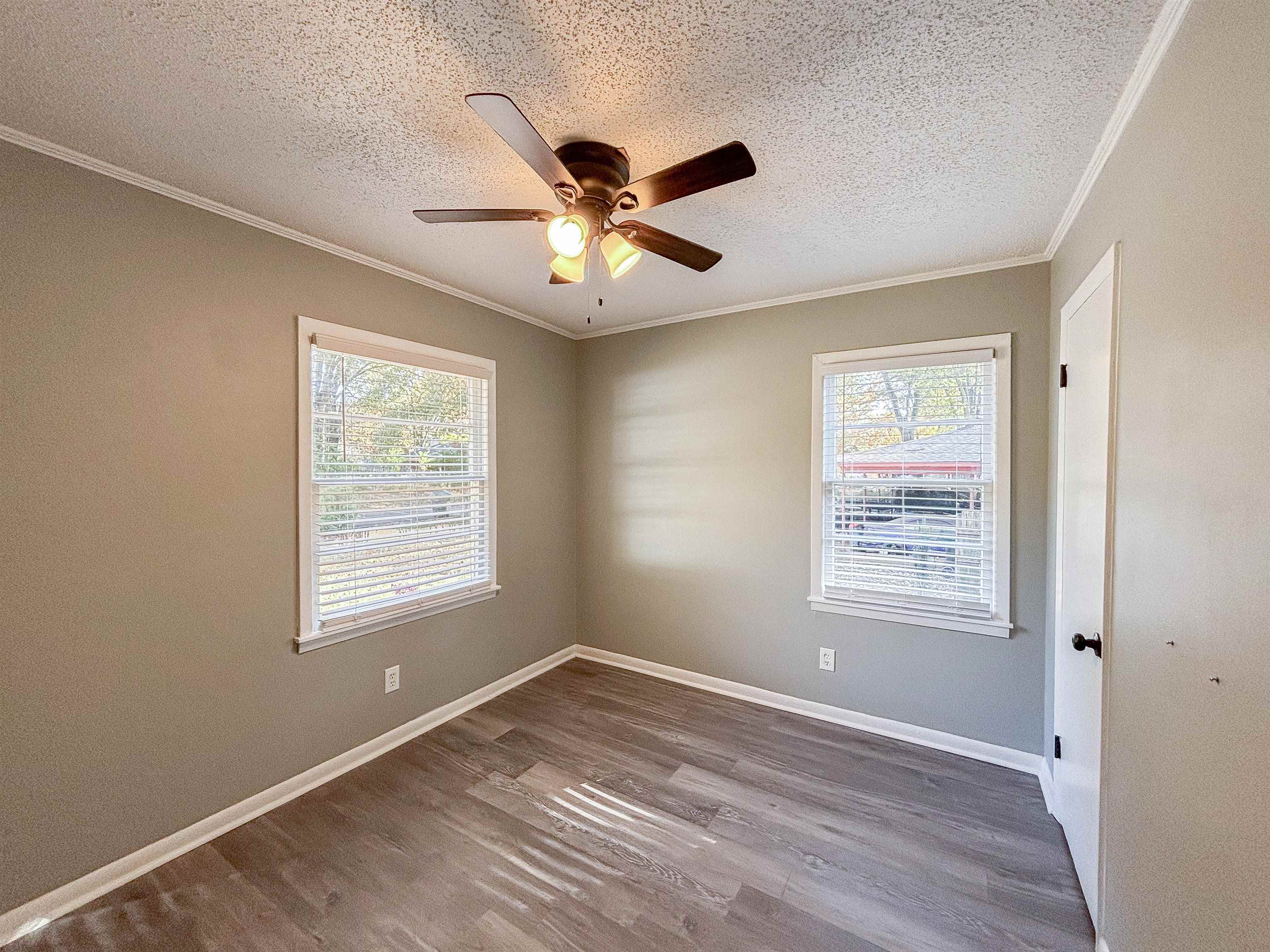 3057 Keats Road Bartlett, TN 38134 - Photo 17 of 23 Spare room with a textured ceiling, ornamental molding, plenty of natural light, wood finished floors, and ceiling fan