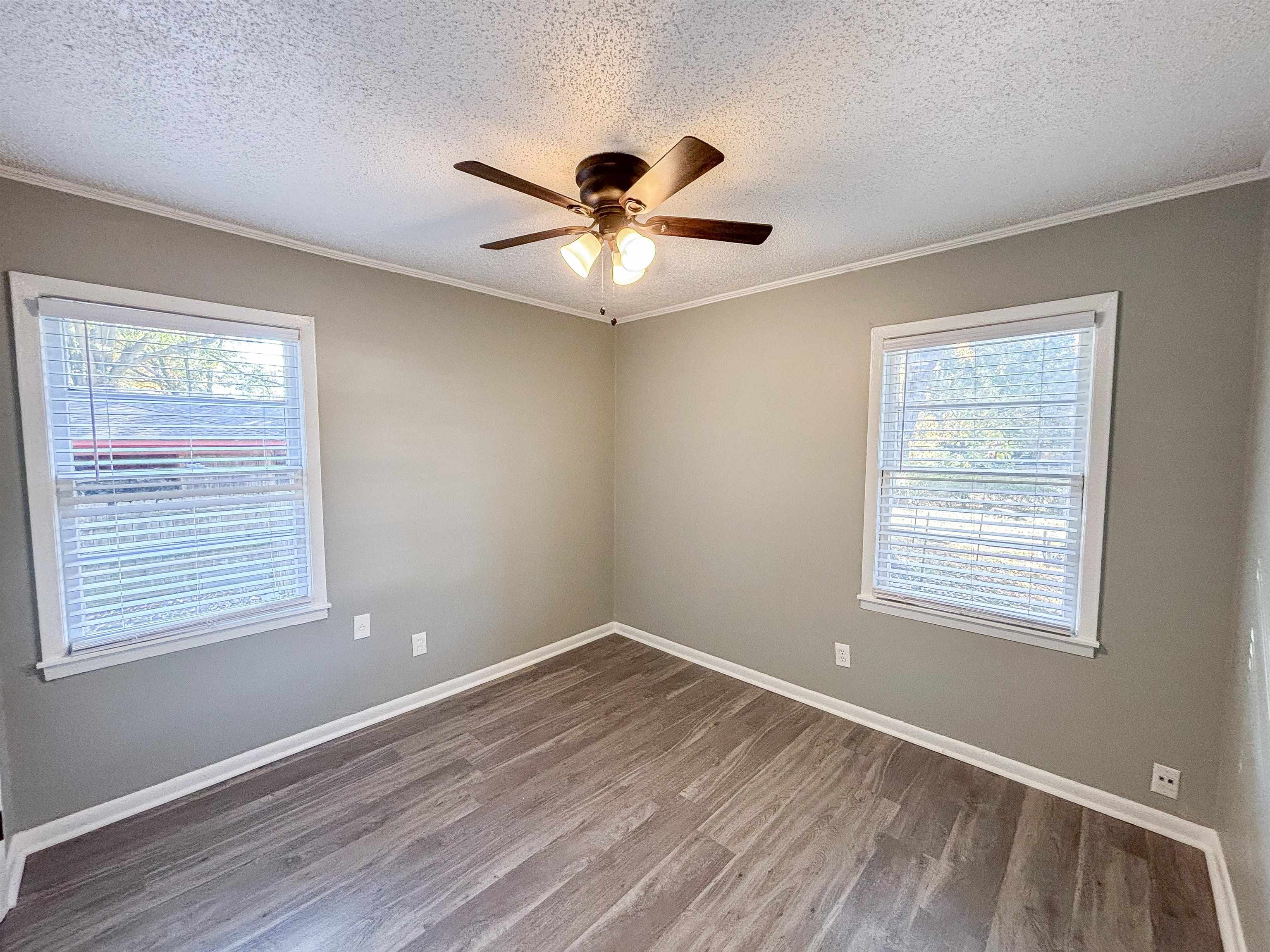 3057 Keats Road Bartlett, TN 38134 - Photo 19 of 23 Unfurnished room featuring a textured ceiling, wood finished floors, crown molding, healthy amount of natural light, and ceiling fan