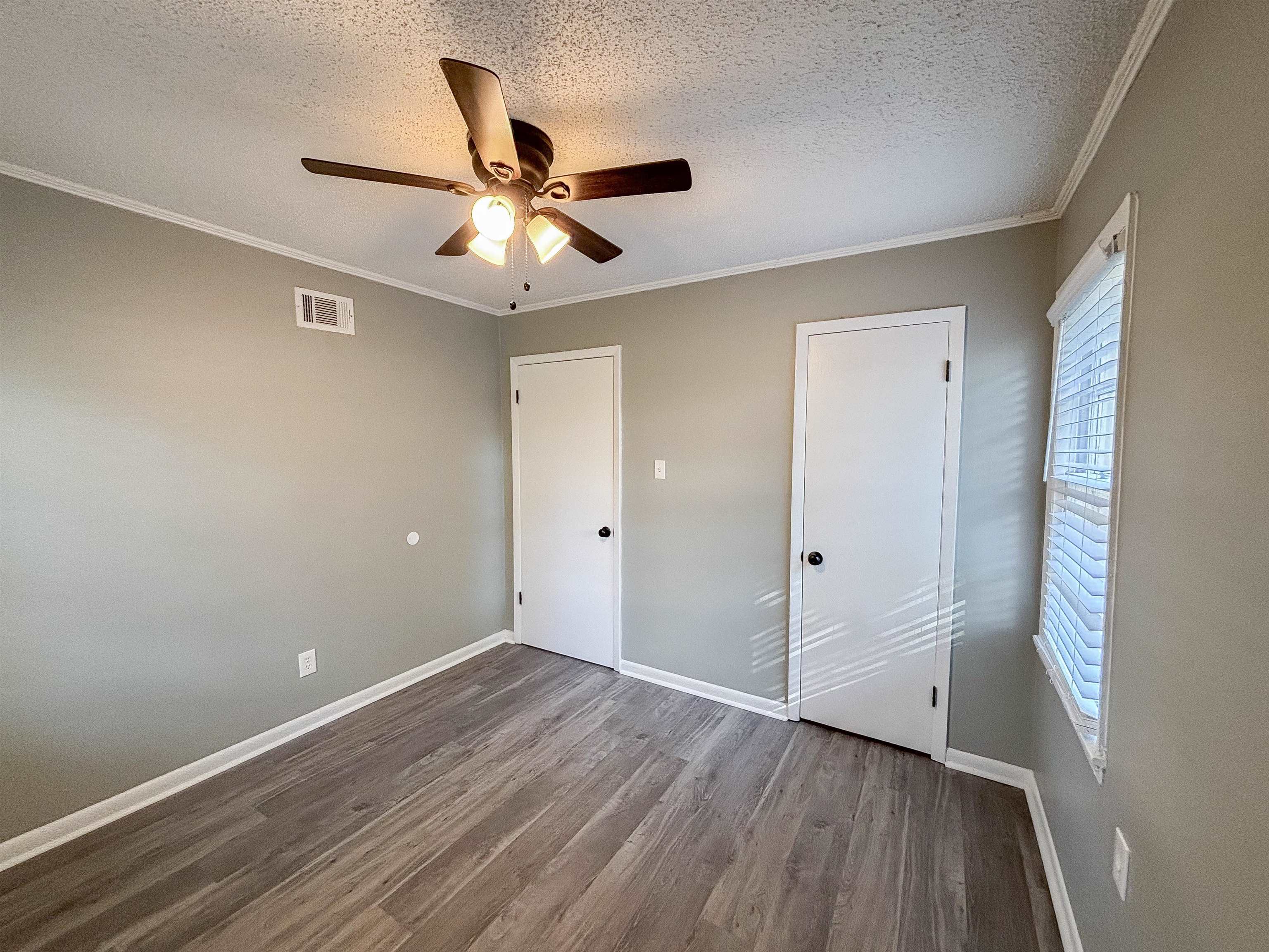 3057 Keats Road Bartlett, TN 38134 - Photo 20 of 23 Unfurnished bedroom featuring a textured ceiling, wood finished floors, ornamental molding, and a ceiling fan