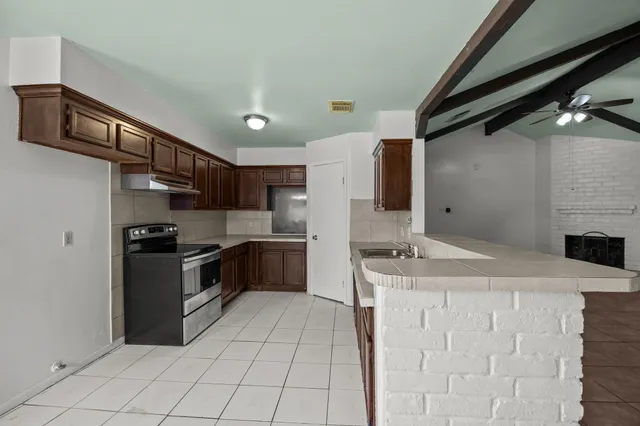 a kitchen with stainless steel appliances granite countertop a sink and a stove