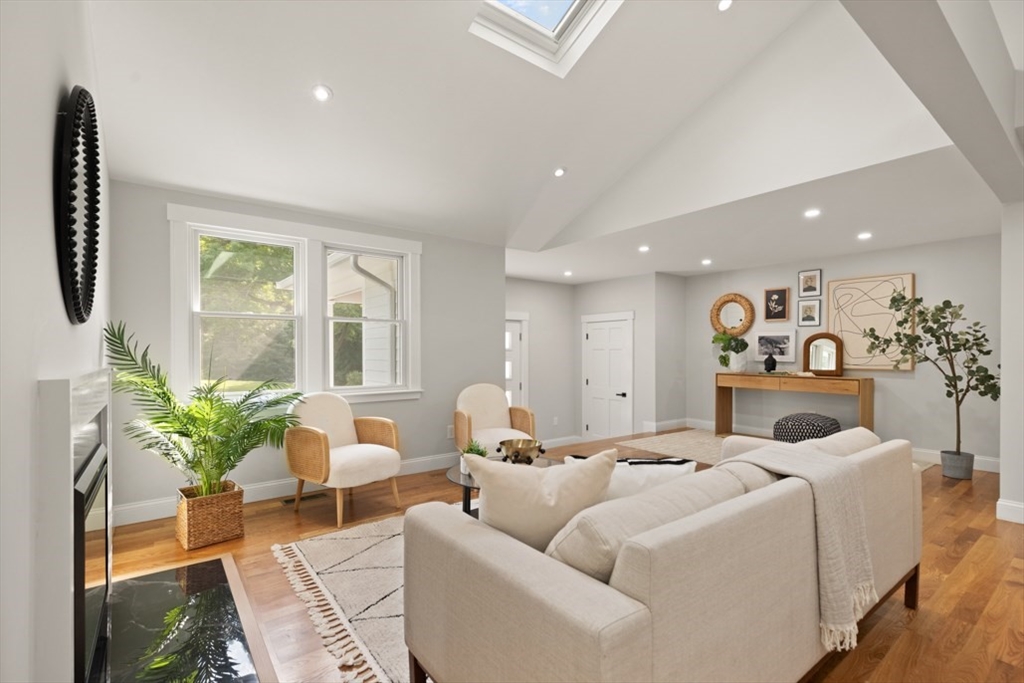 17 Saunders Road Lynnfield, MA 01940 - Photo 11 of 42 a living room with furniture fireplace and a potted plant