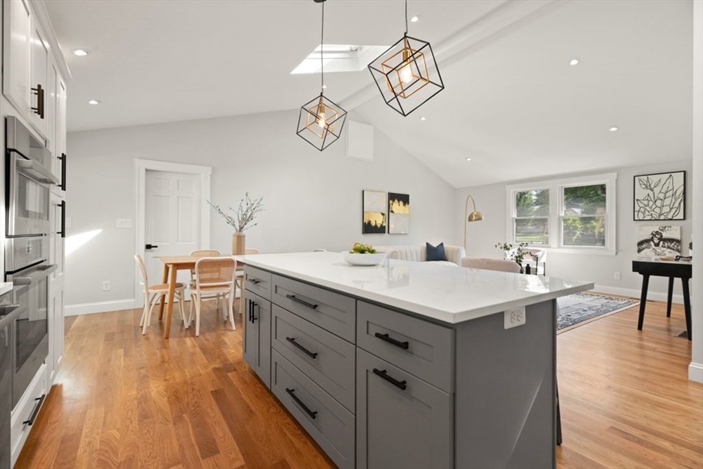 17 Saunders Road Lynnfield, MA 01940 - Photo 18 of 42 a kitchen with a table chairs refrigerator and cabinets