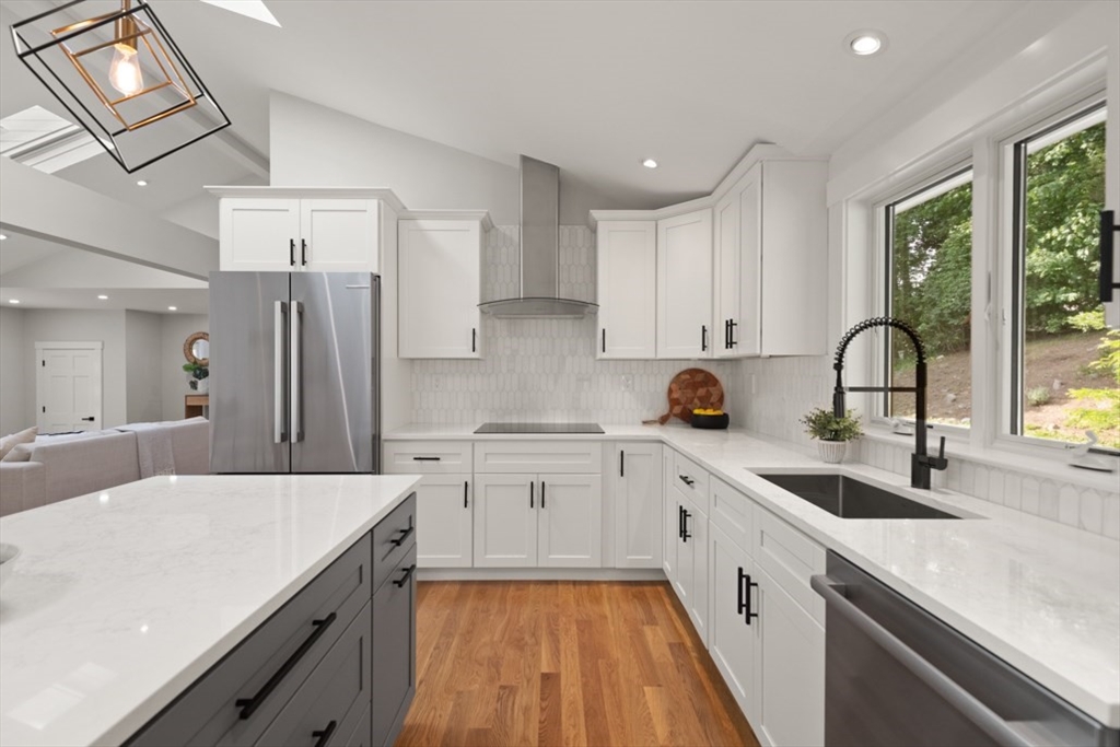 17 Saunders Road Lynnfield, MA 01940 - Photo 19 of 42 a kitchen with a sink a counter top space stainless steel appliances cabinets and a large window
