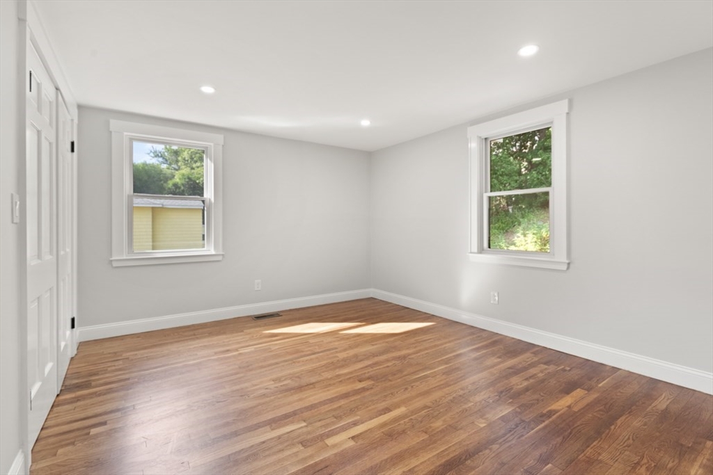 17 Saunders Road Lynnfield, MA 01940 - Photo 20 of 42 a view of an empty room with wooden floor and a window
