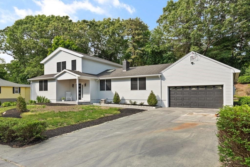 17 Saunders Road Lynnfield, MA 01940 - Photo 2 of 42 a front view of a house with a yard and garage