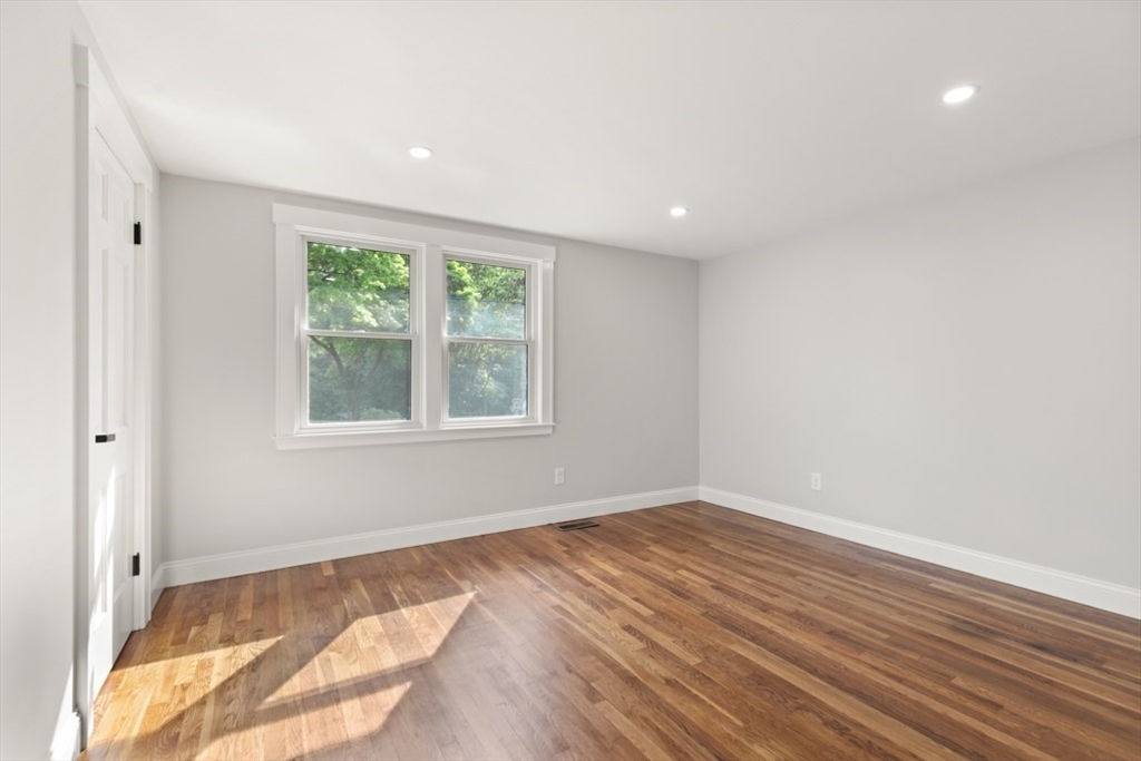 17 Saunders Road Lynnfield, MA 01940 - Photo 21 of 42 a view of an empty room with wooden floor and a window