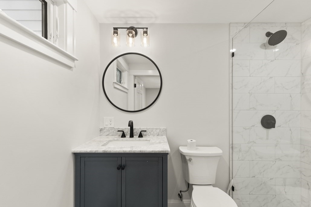 17 Saunders Road Lynnfield, MA 01940 - Photo 28 of 42 a bathroom with a sink a toilet and a mirror