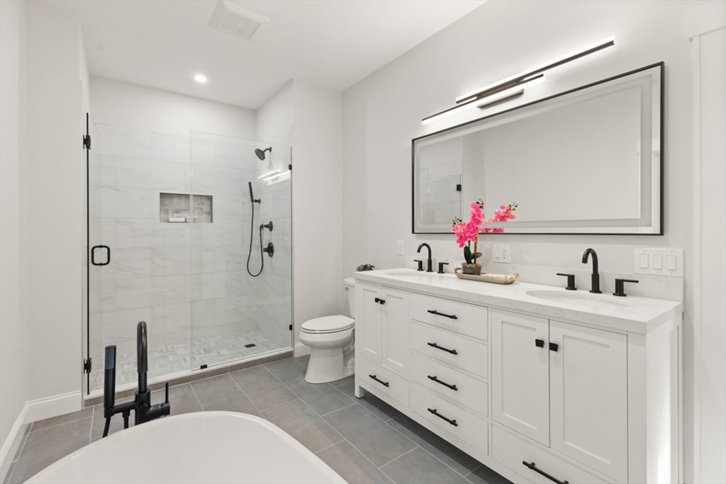 17 Saunders Road Lynnfield, MA 01940 - Photo 30 of 42 a bathroom with a toilet a sink and a mirror