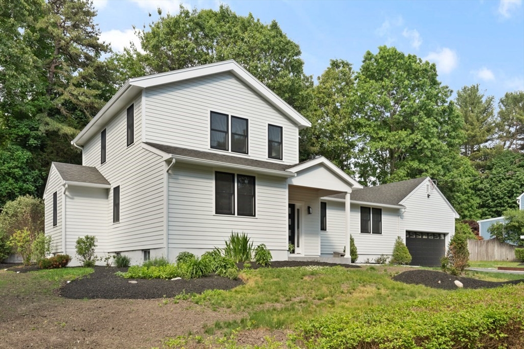 17 Saunders Road Lynnfield, MA 01940 - Photo 3 of 42 a front view of a house with a yard and garage